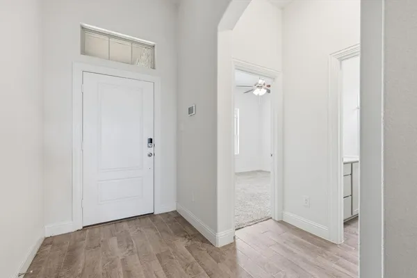 an empty room with wooden floor