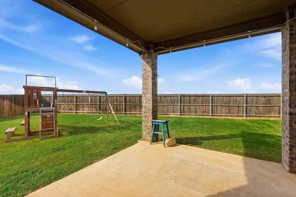 a view of a backyard with table and chairs
