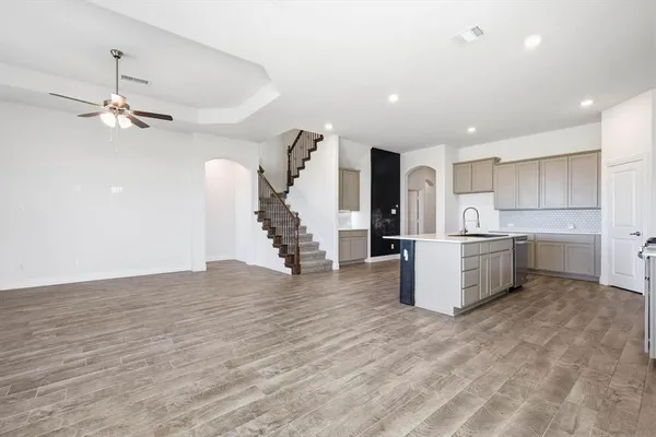 a view of a kitchen with furniture and a ceiling fan