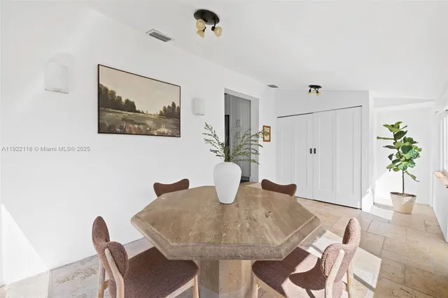 a dining room with furniture and window