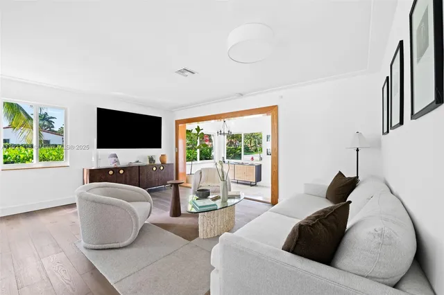 a kitchen with stainless steel appliances a white table and chairs in it