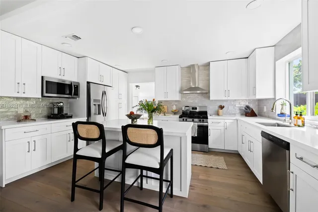 a view of living room with flat screen tv and window