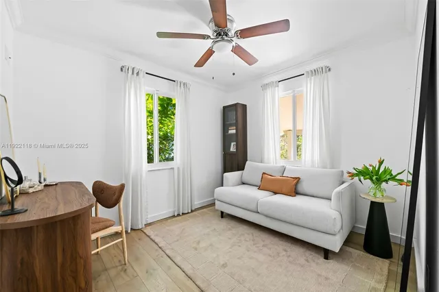 a dining room with furniture and a floor to ceiling window