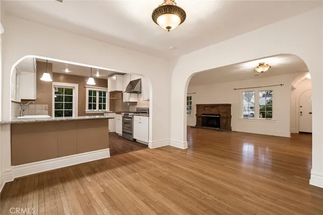 a view of a living room with furniture and a fireplace