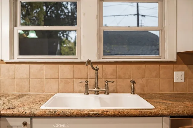 a bathroom with a granite countertop sink and mirror