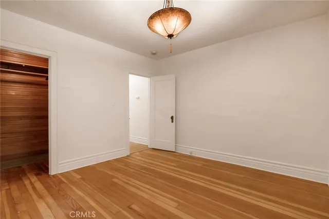 a view of room with wooden floor and fan