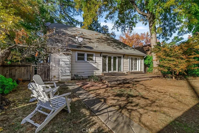 a backyard of a house with table and chairs