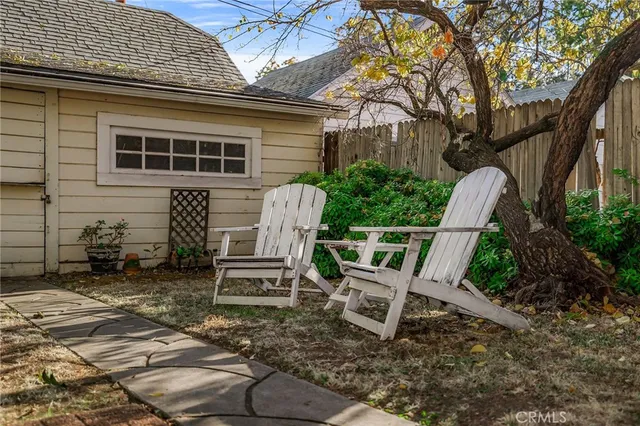 a view of a chairs and table in backyard