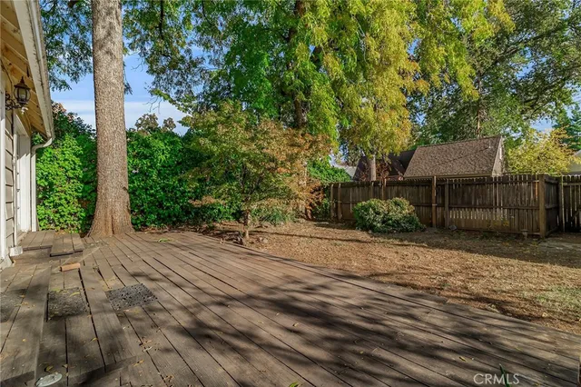 a wooden bench sitting in middle of a yard