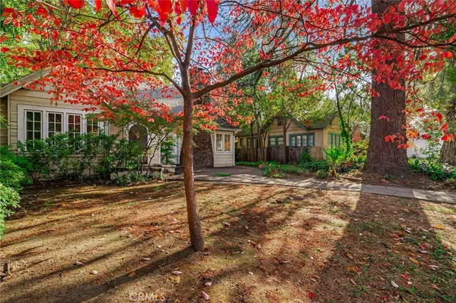 a view of a house with yard and tree s