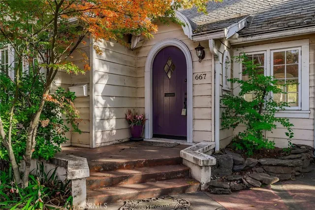 a front view of a house with a garden