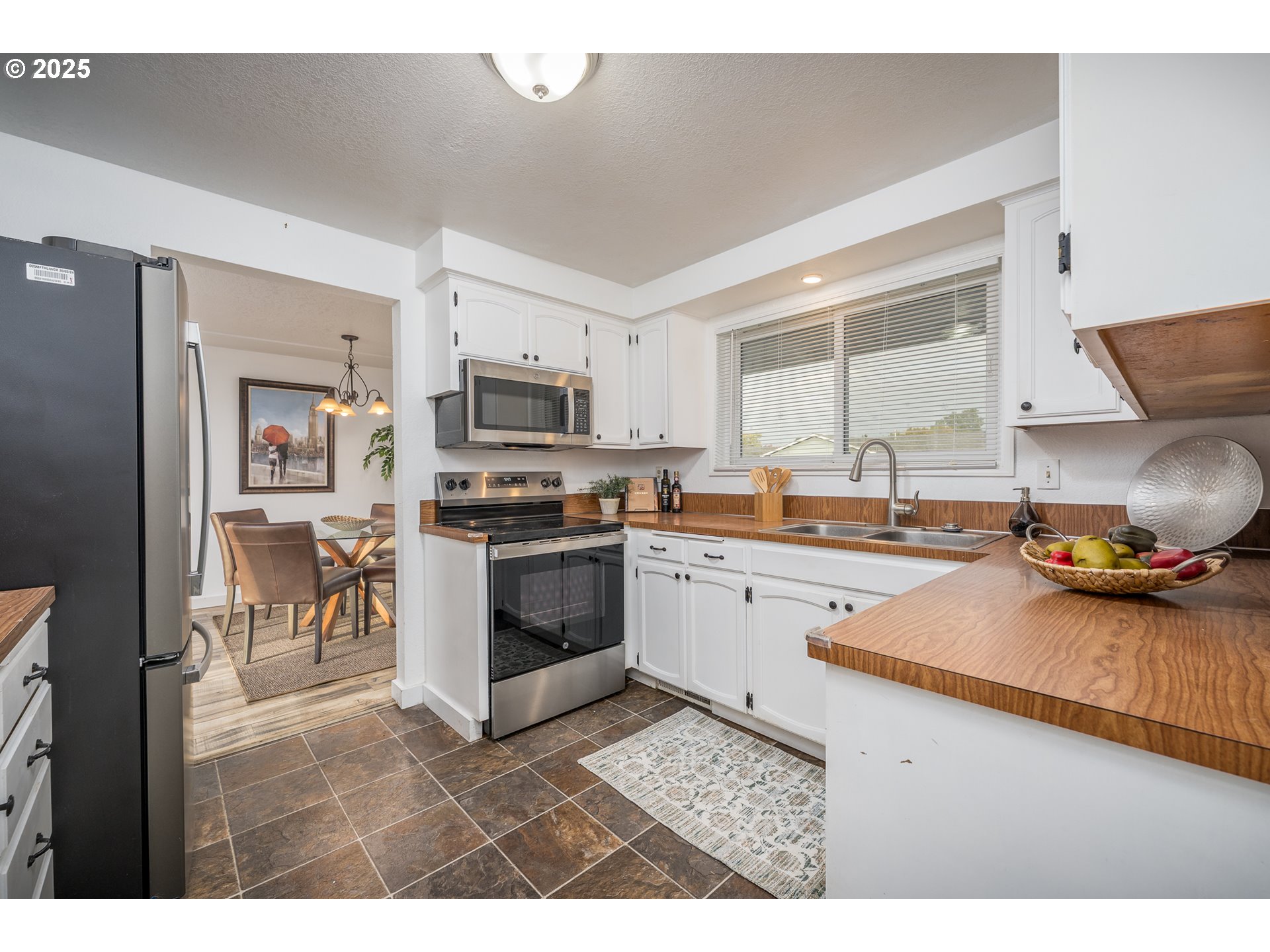 2676 Wheeler Street Southeast Albany, OR 97322 - Photo 11 of 32 a kitchen with granite countertop a stove top oven a sink a counter top space and cabinets