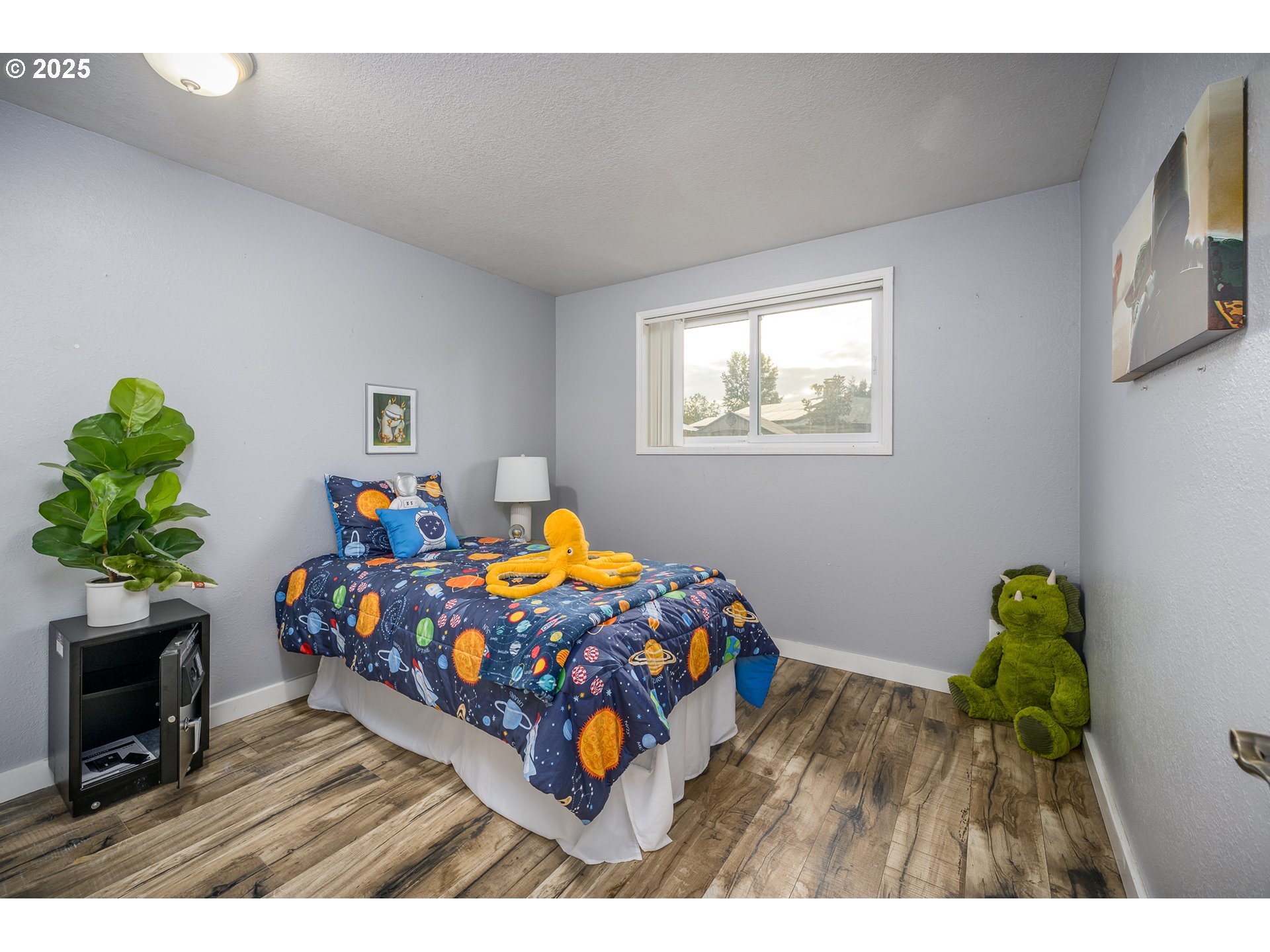 2676 Wheeler Street Southeast Albany, OR 97322 - Photo 15 of 32 a bedroom with a bed a window and a potted plant on table