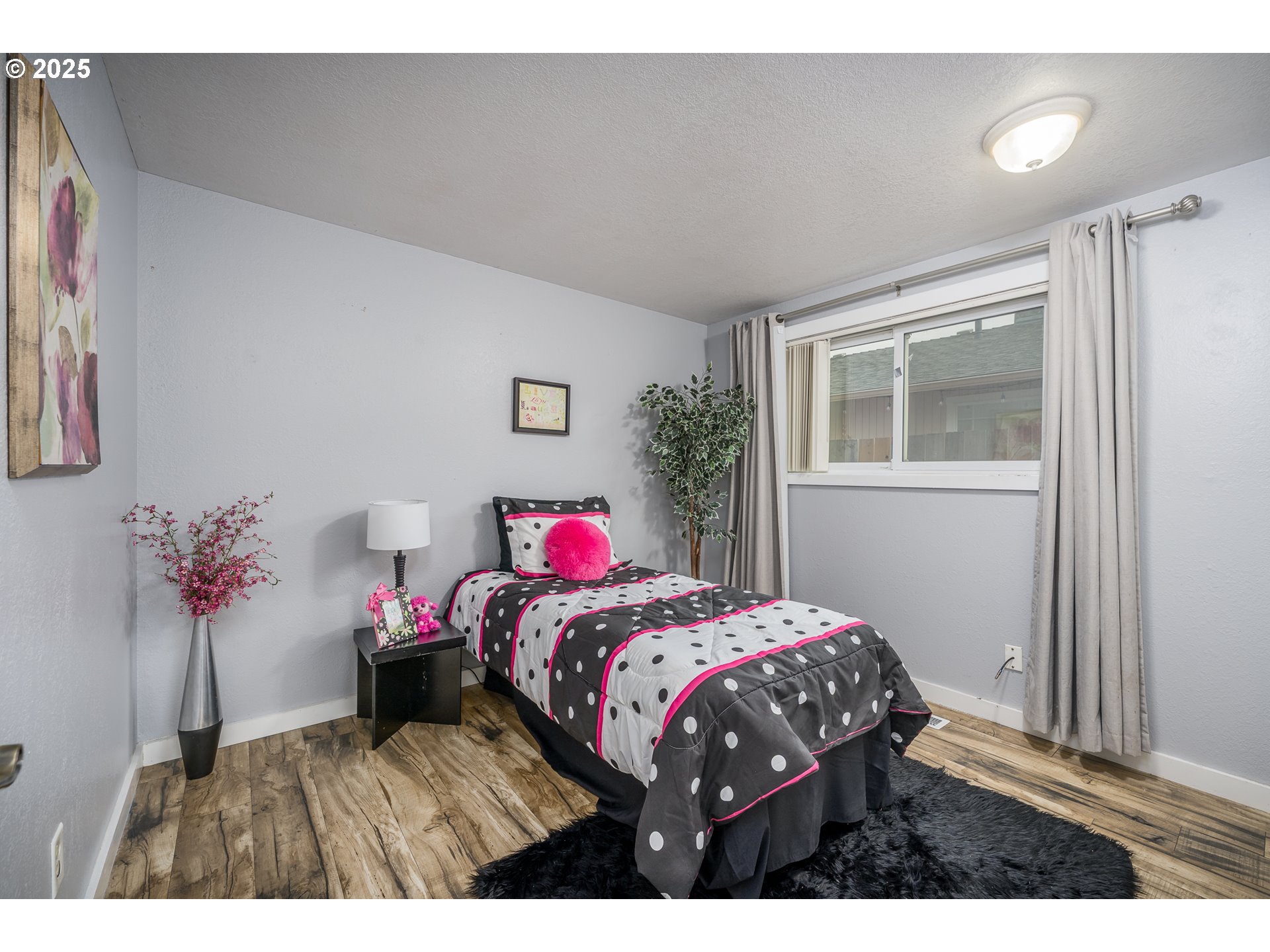 2676 Wheeler Street Southeast Albany, OR 97322 - Photo 16 of 32 a bedroom with a bed potted plant and a window