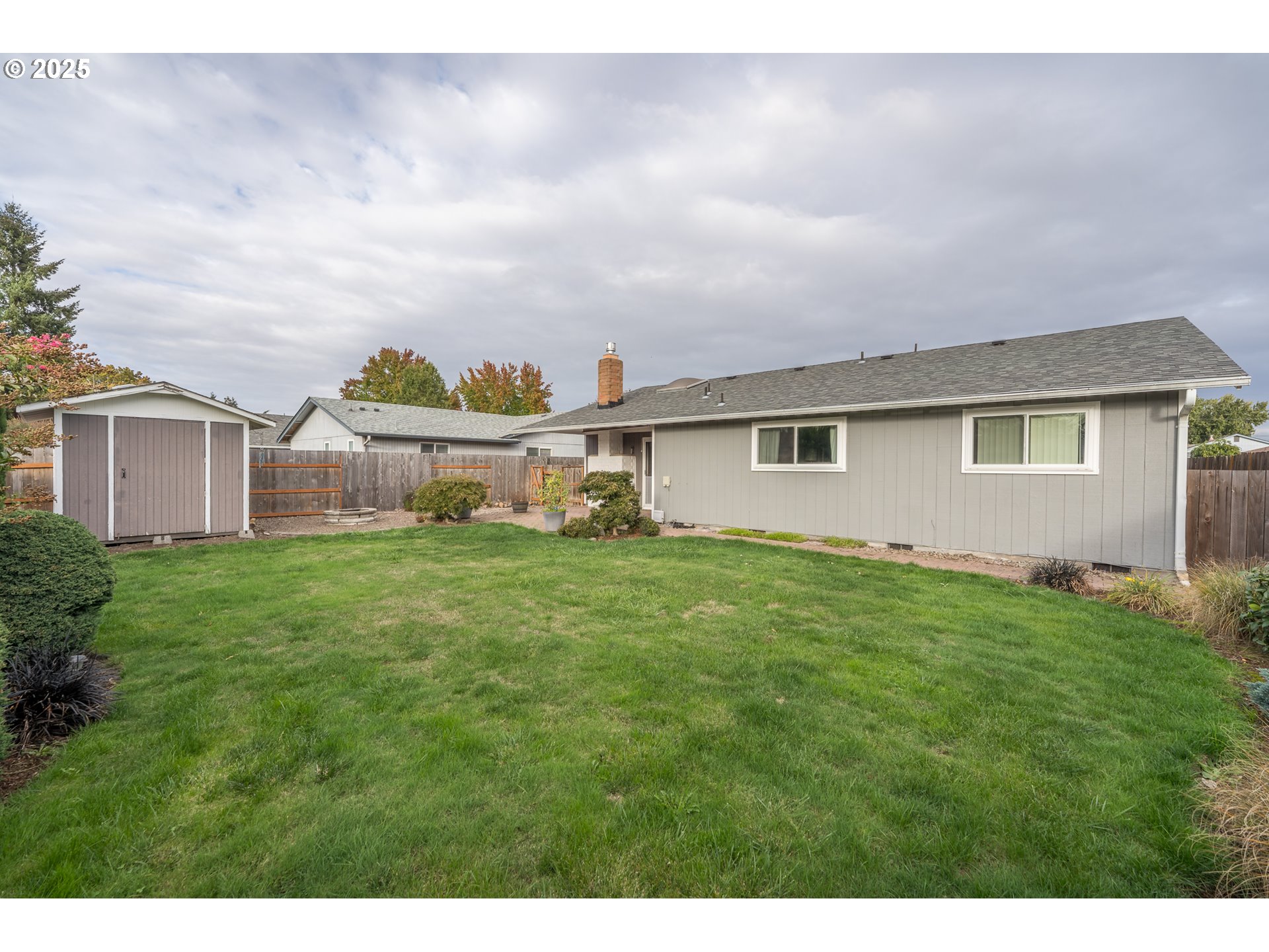 2676 Wheeler Street Southeast Albany, OR 97322 - Photo 23 of 32 a view of a house with a big yard and large trees