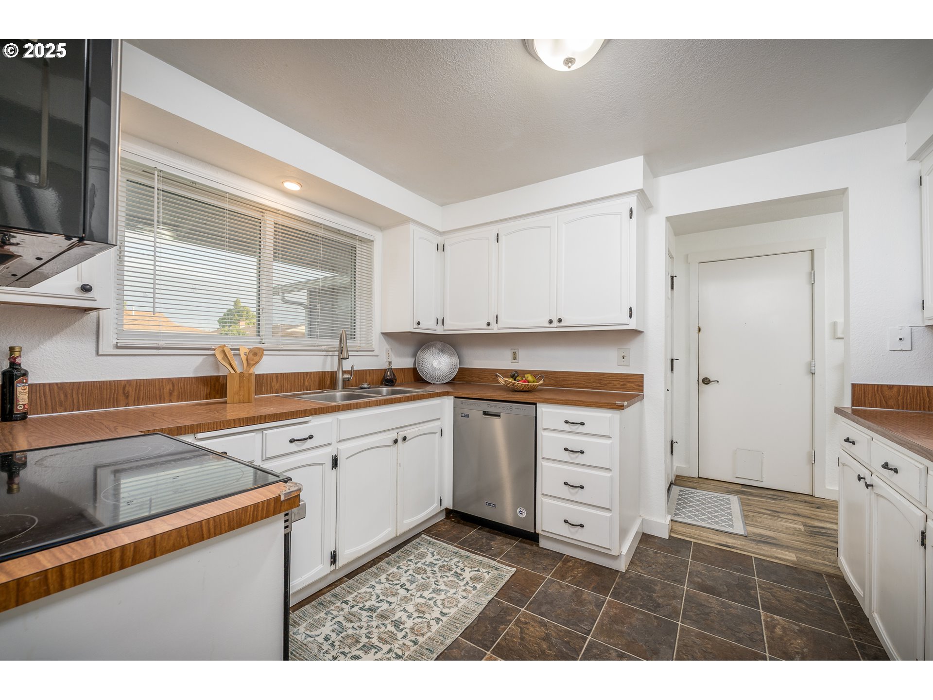 2676 Wheeler Street Southeast Albany, OR 97322 - Photo 9 of 32 a kitchen with white cabinets and white appliances