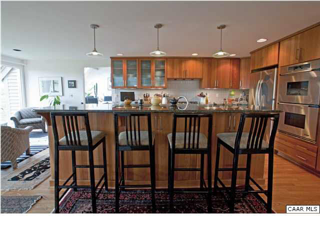 3280 Ridge Road Charlottesville, VA 22901 - Photo 14 of 30 a kitchen with stainless steel appliances kitchen island granite countertop a dining table chairs sink and cabinets