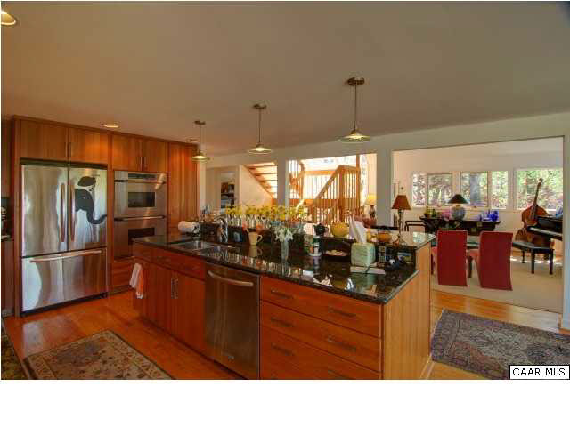 3280 Ridge Road Charlottesville, VA 22901 - Photo 4 of 30 a kitchen with stainless steel appliances granite countertop a refrigerator a sink dishwasher with a dining table and chairs