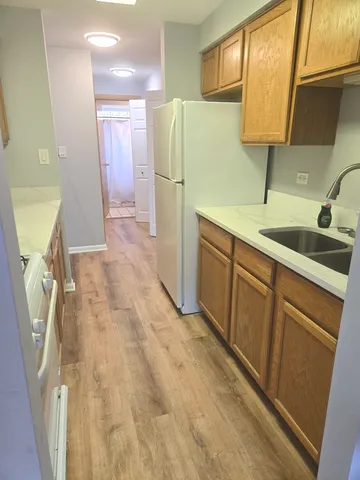 a kitchen with a sink a refrigerator and a sink