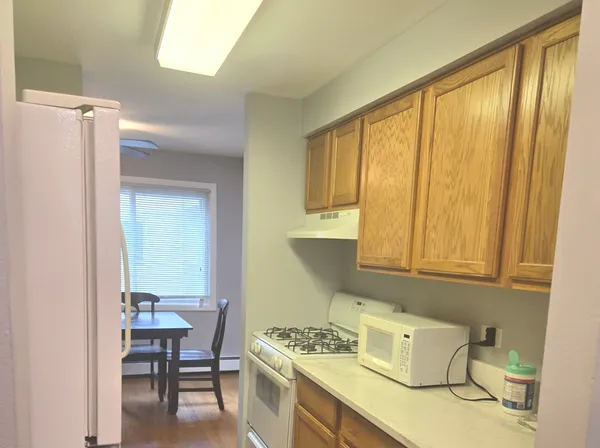 a kitchen that has a table and chairs in it
