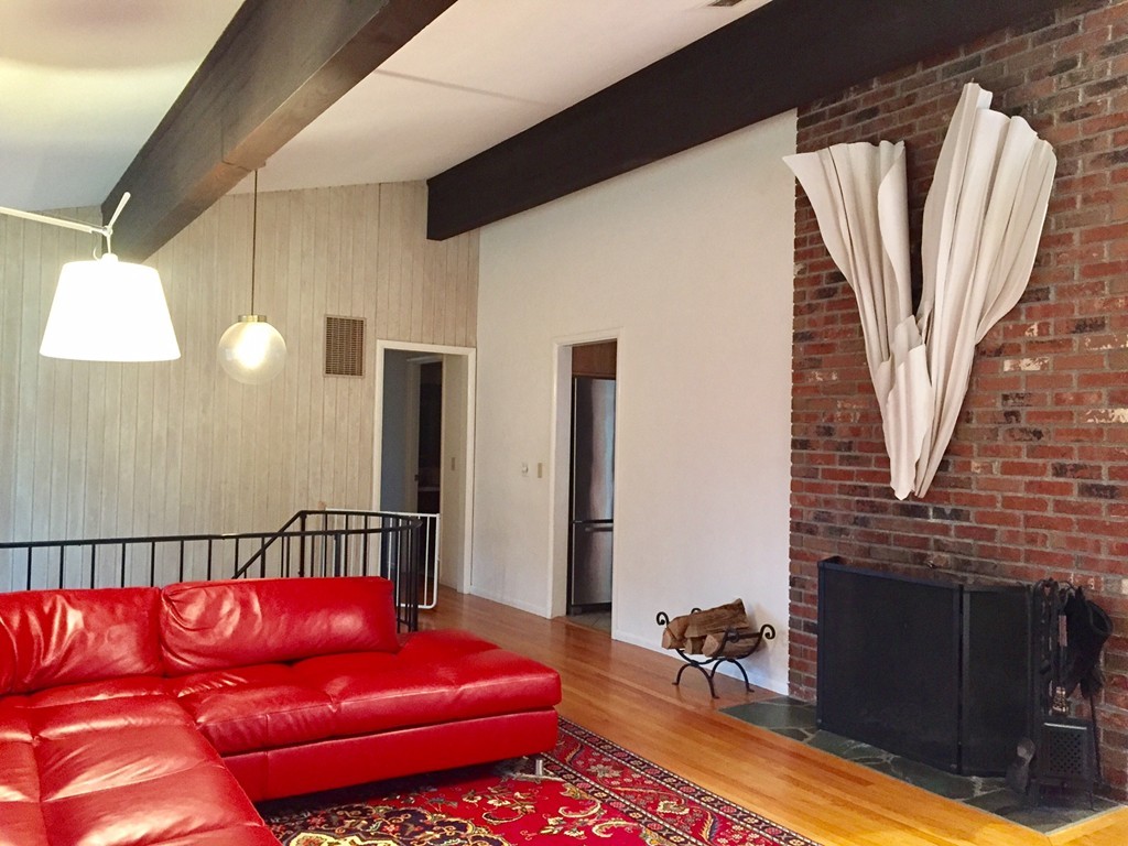 279 Market Hill Road Amherst, MA 01002 - Photo 7 of 30 a living room with furniture a fireplace and a chandelier