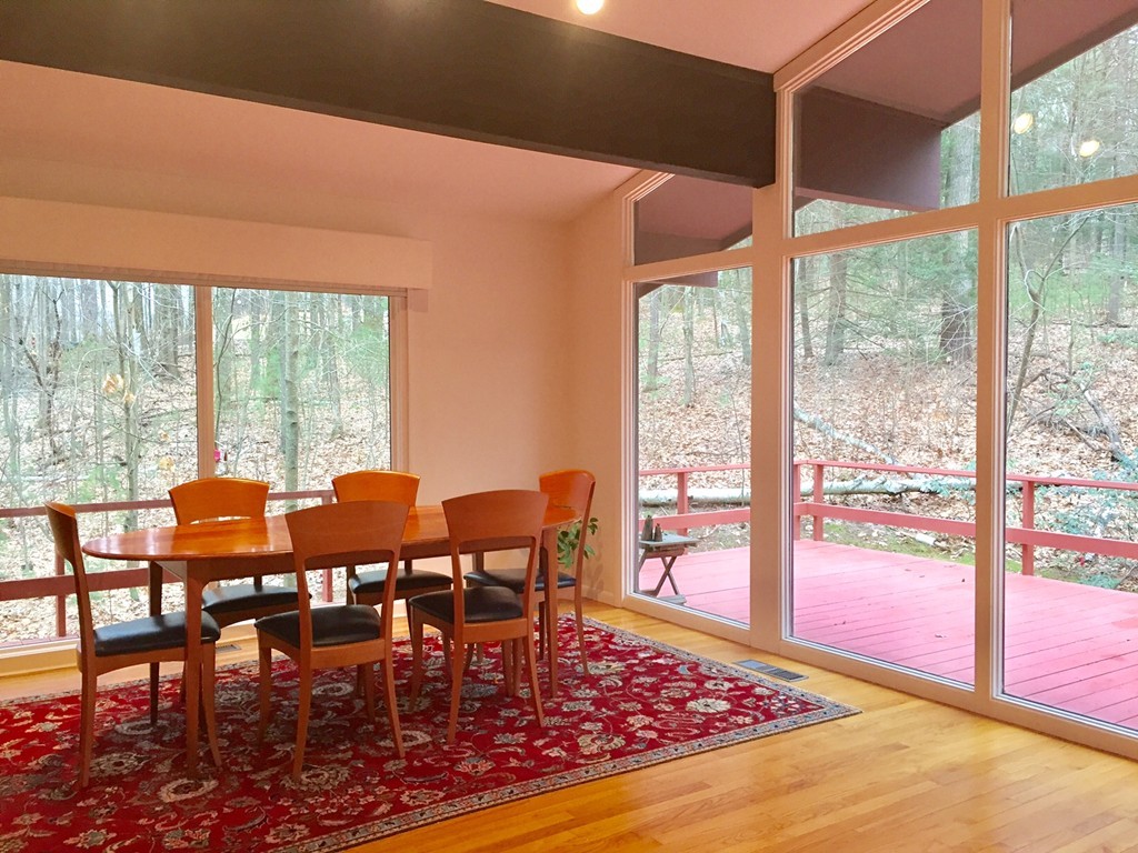 279 Market Hill Road Amherst, MA 01002 - Photo 8 of 30 a view of a dining room with furniture large windows and wooden floor