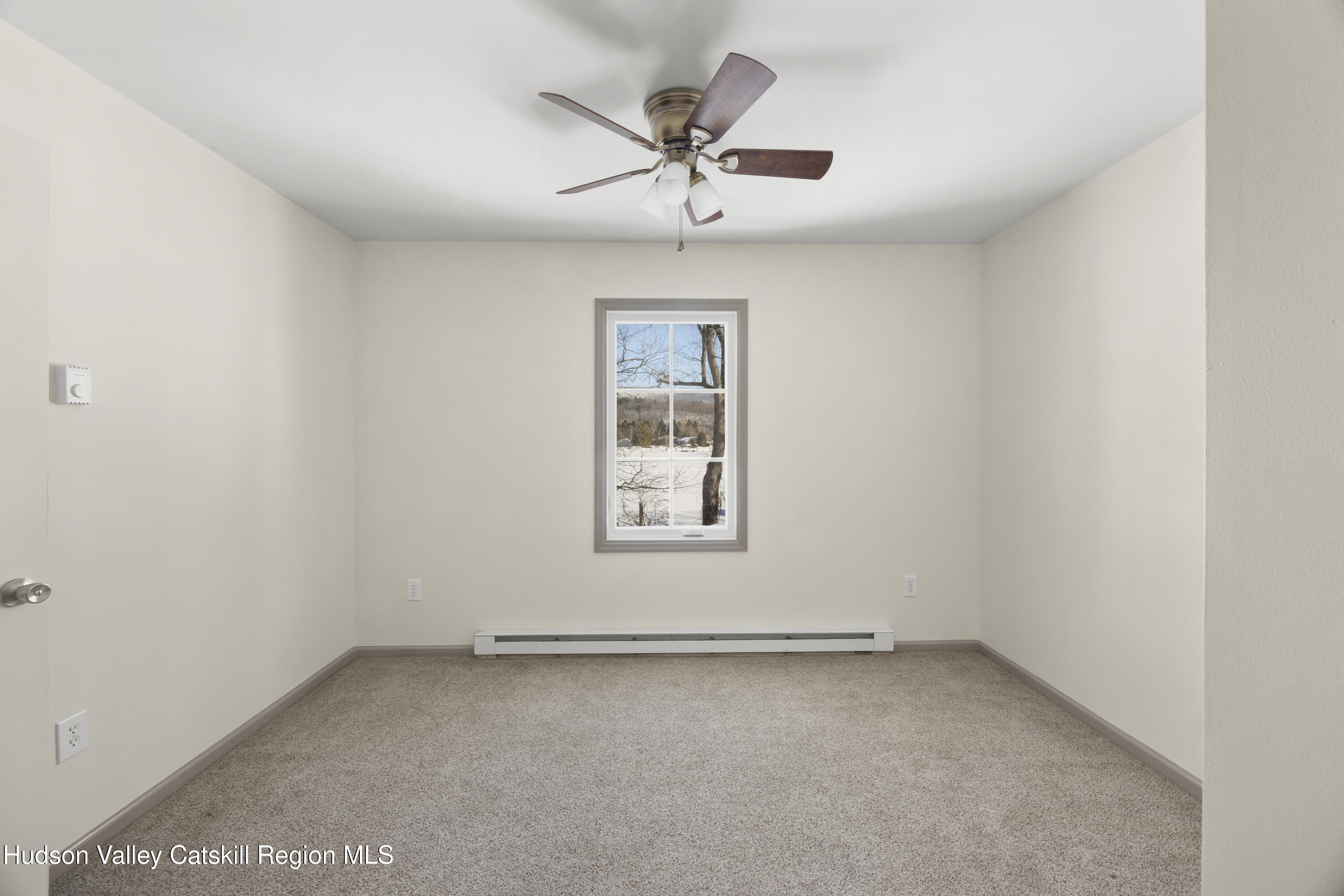 116 Lincoln Road Copake, NY 12516 - Photo 14 of 20 an empty room with a window and a ceiling fan