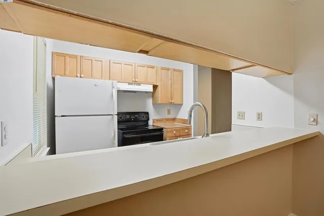 a kitchen with a refrigerator and a sink