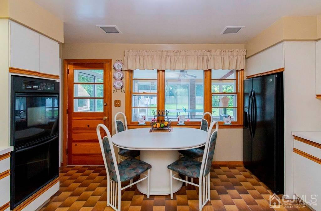 11 Hilltop Road Edison, NJ 08820 - Photo 14 of 30 a dining room with furniture a chandelier and wooden floor