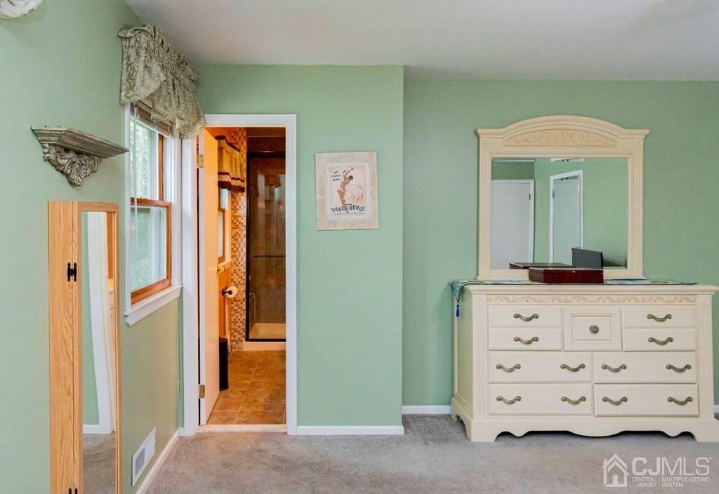 11 Hilltop Road Edison, NJ 08820 - Photo 16 of 30 a view of a bedroom with a dresser and a mirror