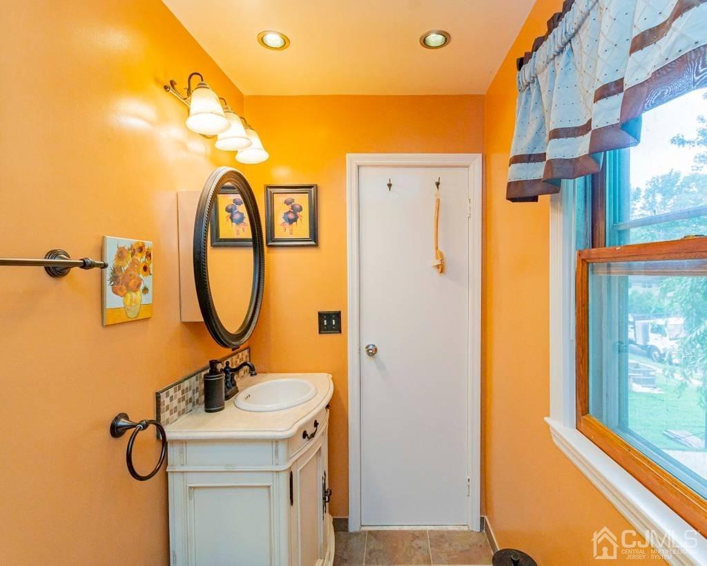 11 Hilltop Road Edison, NJ 08820 - Photo 19 of 30 a bathroom with a sink a mirror and a shower
