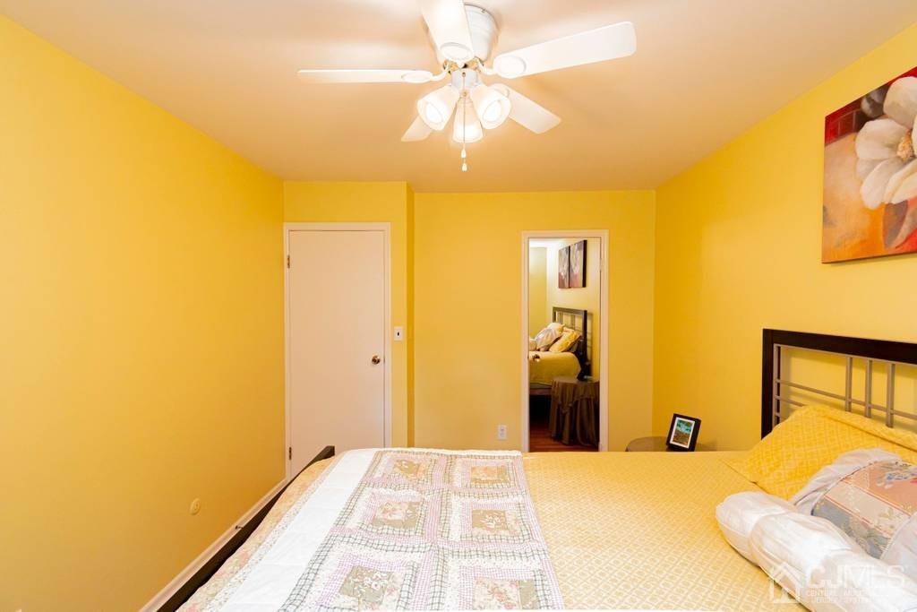 11 Hilltop Road Edison, NJ 08820 - Photo 21 of 30 a bedroom with a bed and a chandelier