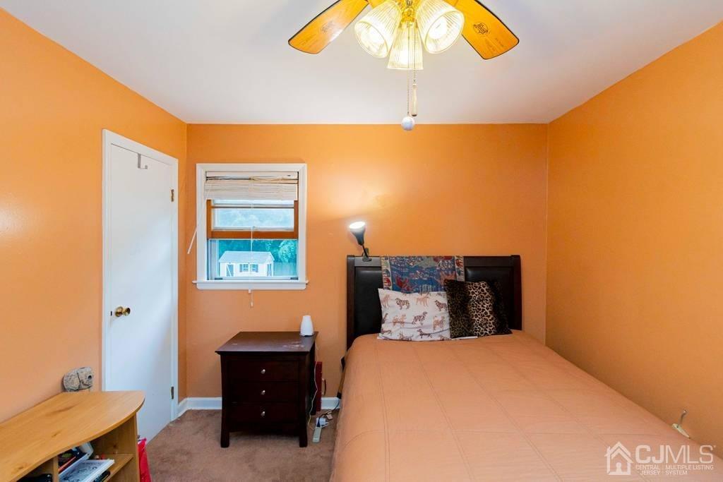 11 Hilltop Road Edison, NJ 08820 - Photo 23 of 30 a bedroom with a bed and a chandelier