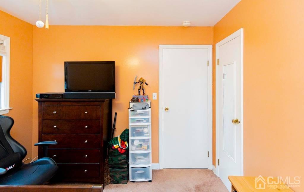 11 Hilltop Road Edison, NJ 08820 - Photo 24 of 30 a living room with furniture and flat screen tv