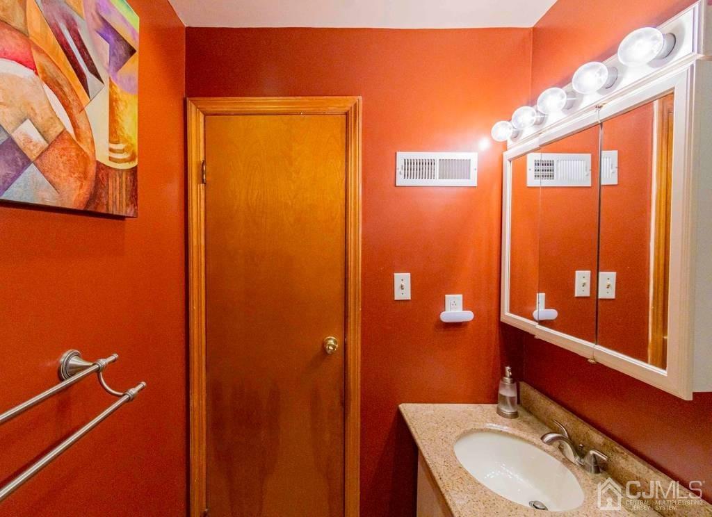 11 Hilltop Road Edison, NJ 08820 - Photo 26 of 30 a bathroom with a sink a toilet and shower