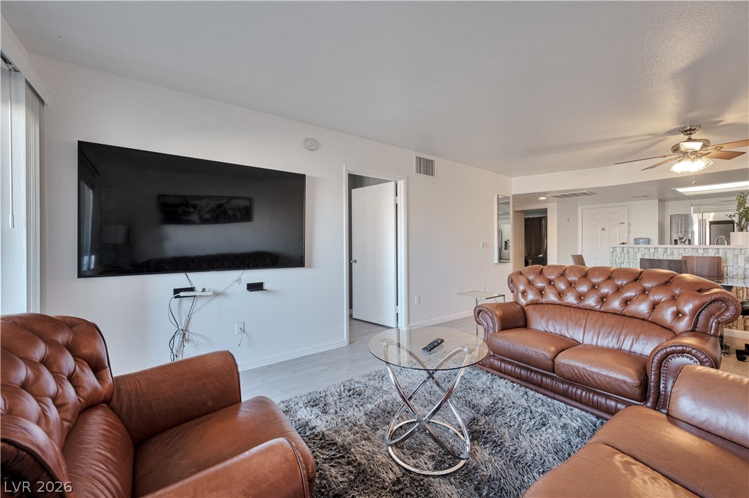 8025 West Russell Road, Unit 1090 Las Vegas, NV 89113 - Photo 5 of 23 An open layout connects the living area seamlessly to the nearby kitchen.