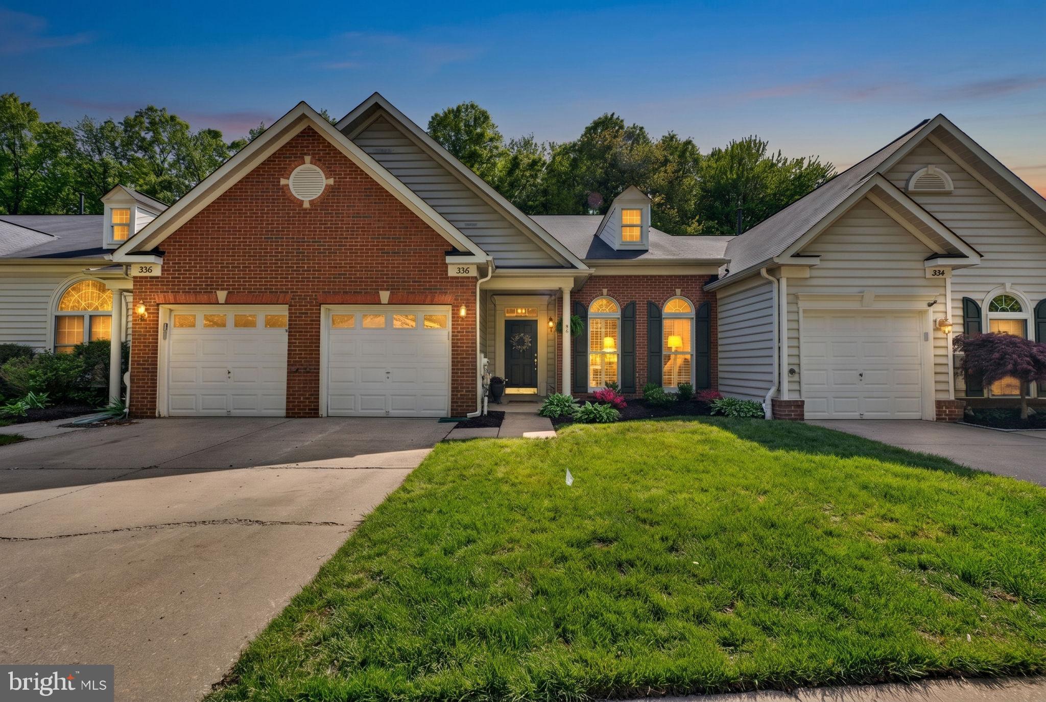 336 Colony Point Place Edgewater, MD 21037 - Photo 2 of 40 a front view of a house with a yard and garage