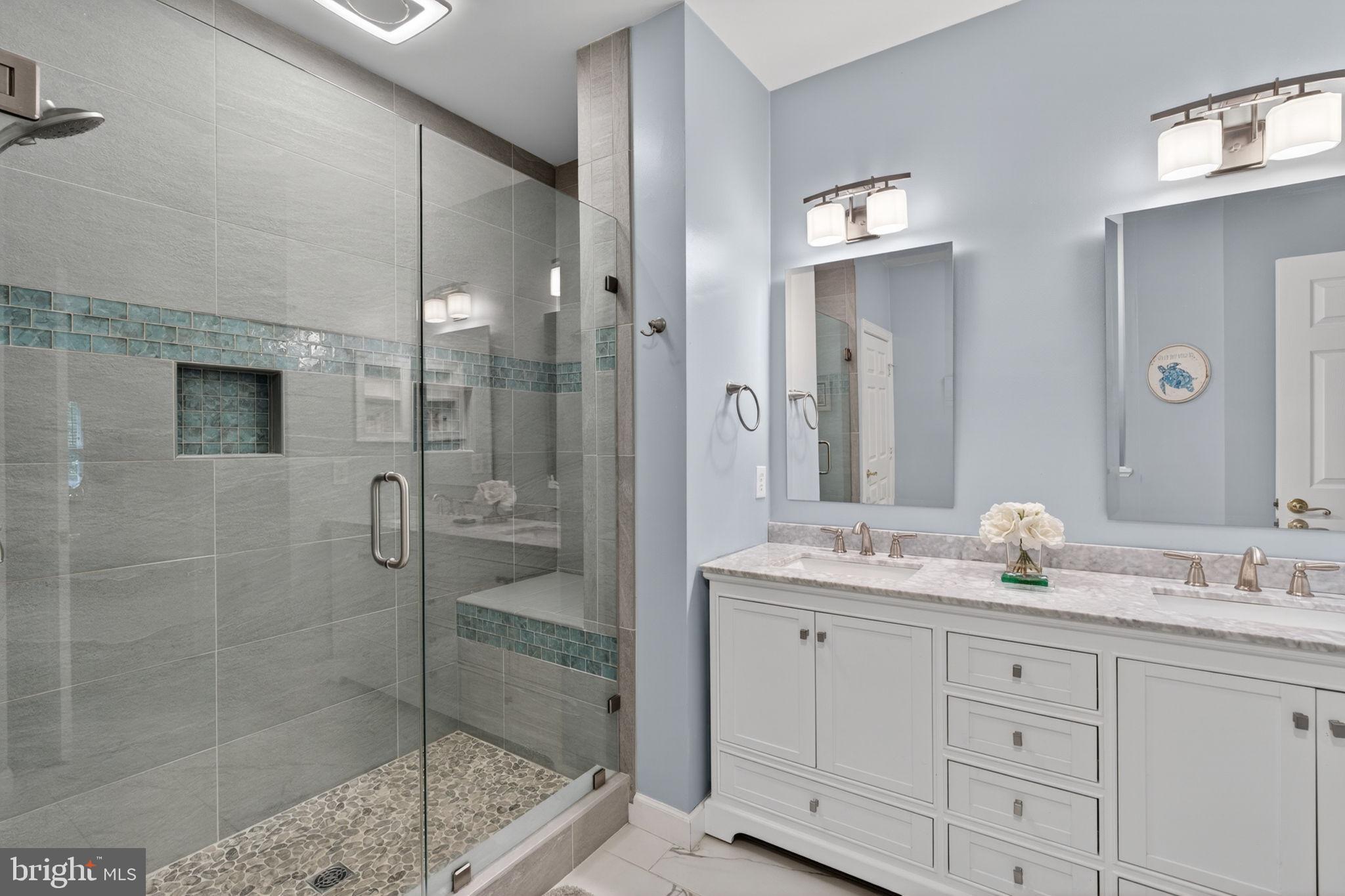 336 Colony Point Place Edgewater, MD 21037 - Photo 24 of 40 a bathroom with a granite countertop sink two mirror and shower