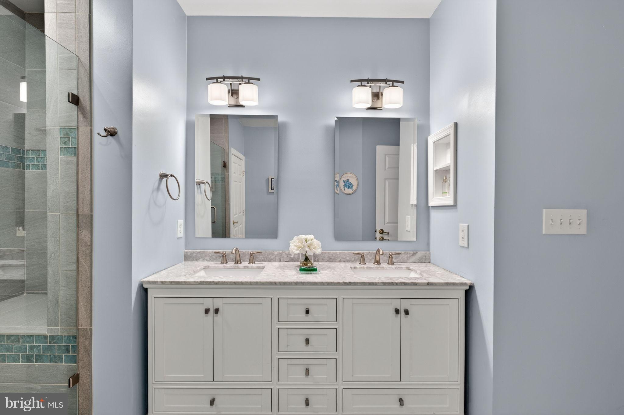 336 Colony Point Place Edgewater, MD 21037 - Photo 25 of 40 a bathroom with double vanity sinks and a mirror