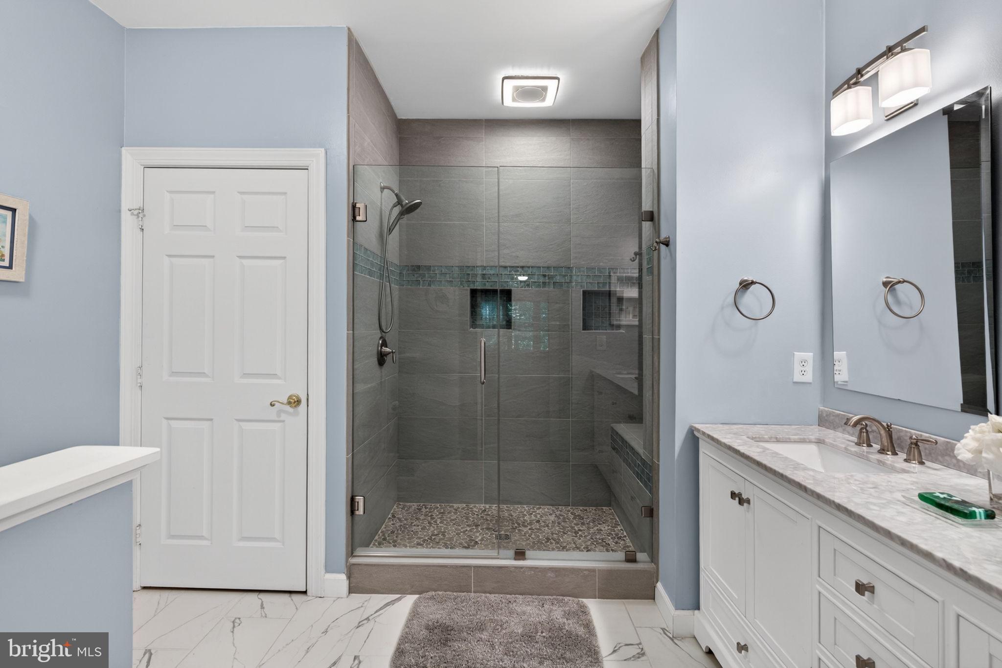 336 Colony Point Place Edgewater, MD 21037 - Photo 26 of 40 a bathroom with a shower sink and mirror