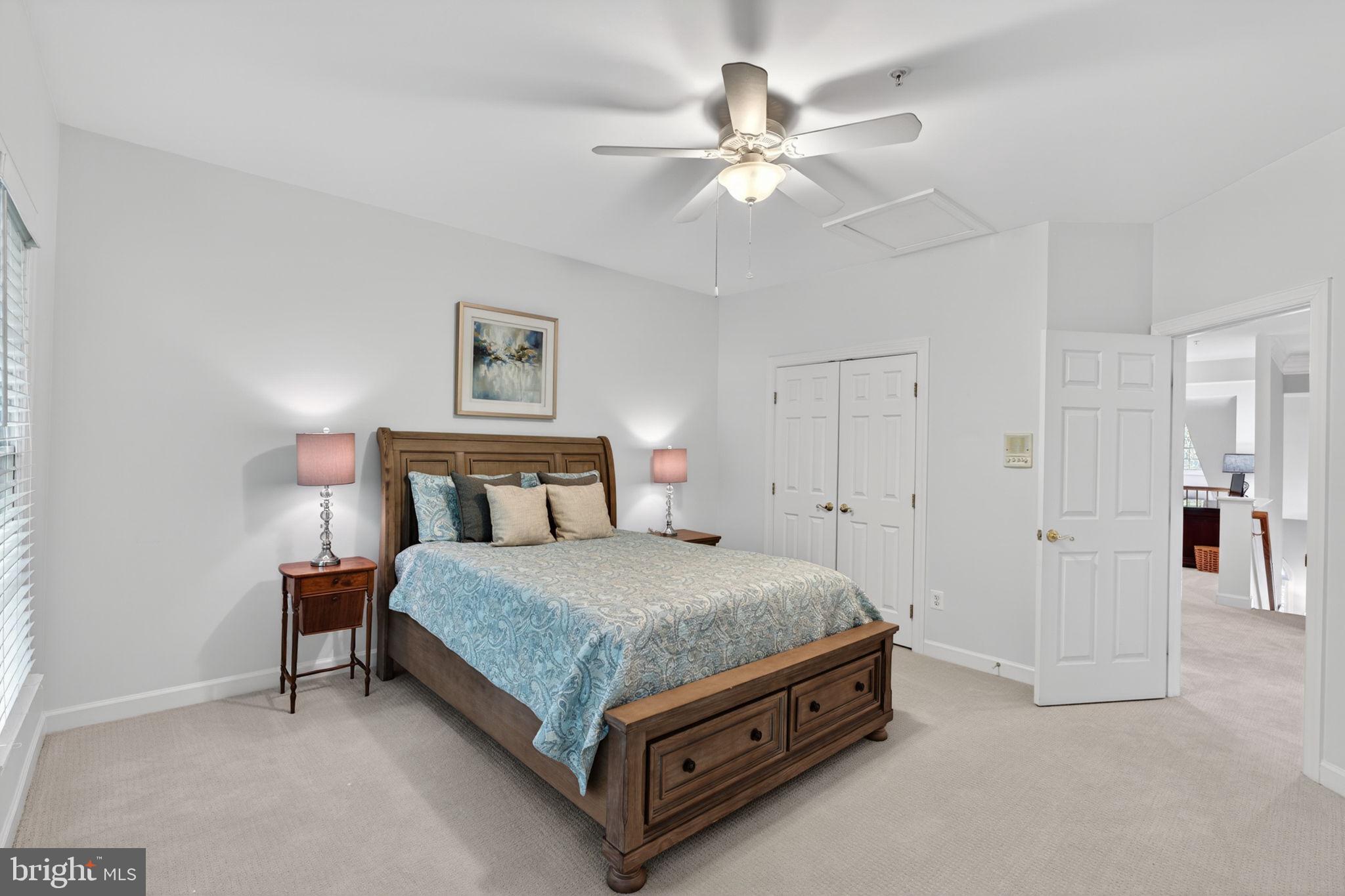 336 Colony Point Place Edgewater, MD 21037 - Photo 33 of 40 a spacious bedroom with a bed and a chandelier