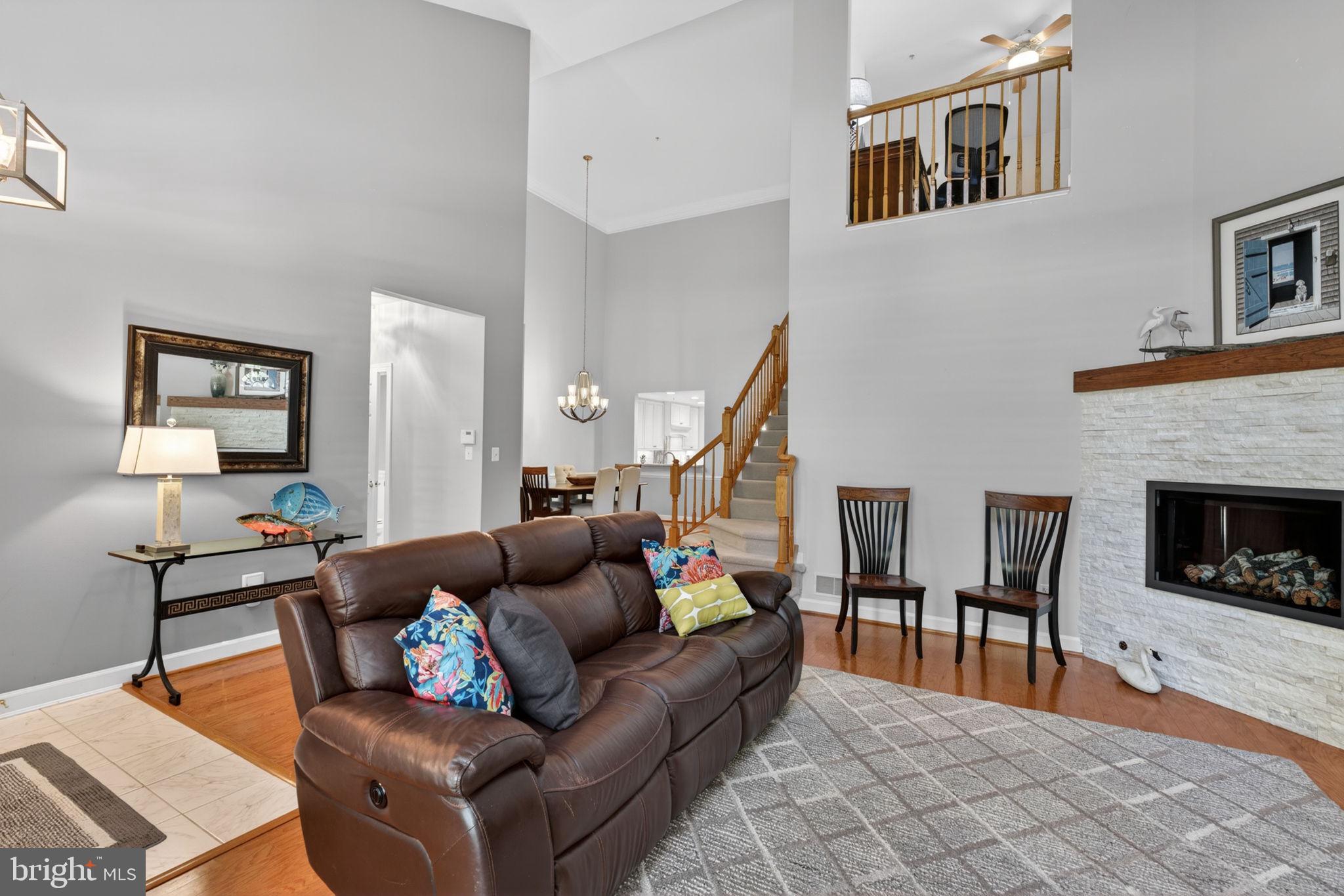336 Colony Point Place Edgewater, MD 21037 - Photo 8 of 40 a living room with furniture and a fireplace