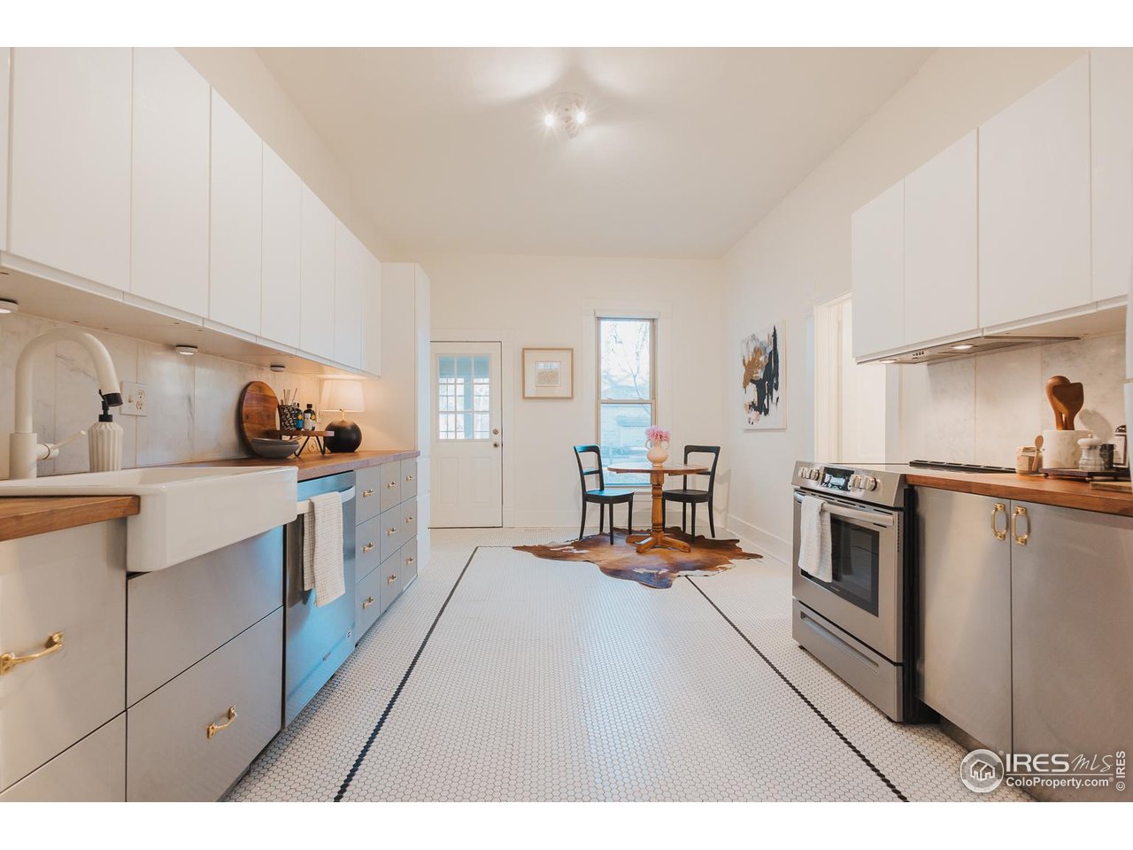 506 South Howes Street Fort Collins, CO 80521 - Photo 14 of 37 a kitchen with stainless steel appliances kitchen island granite countertop a sink and cabinets