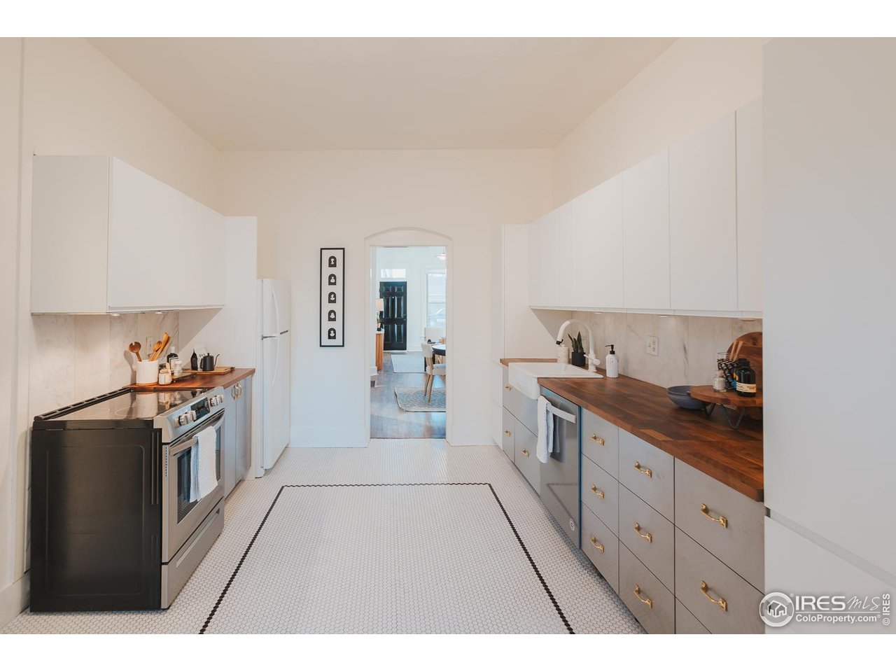 506 South Howes Street Fort Collins, CO 80521 - Photo 16 of 37 a kitchen with stainless steel appliances granite countertop a sink and stove top oven