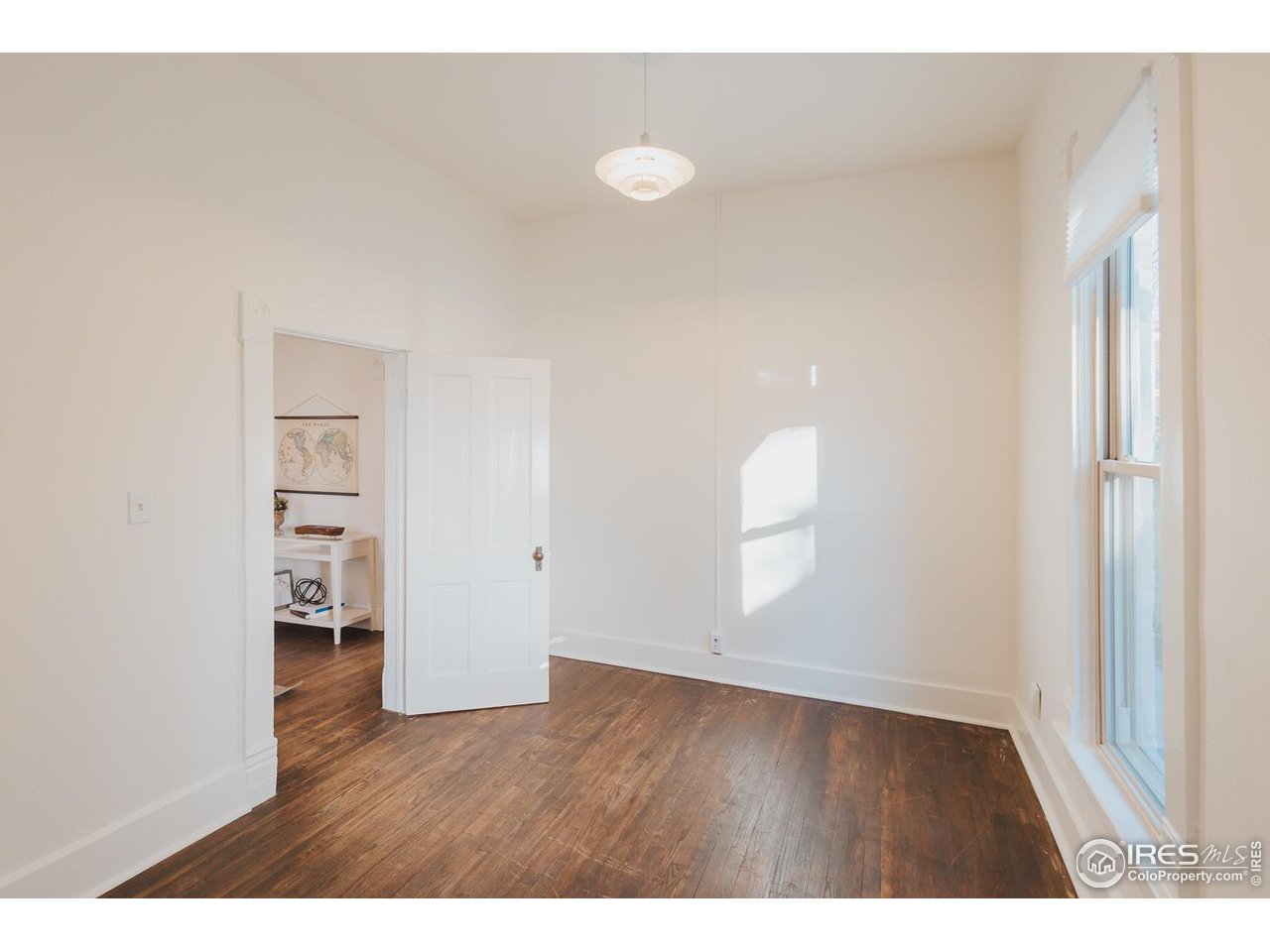 506 South Howes Street Fort Collins, CO 80521 - Photo 28 of 37 a view of an empty room with wooden floor and a window