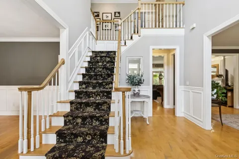 a view of entryway and hall with wooden floor