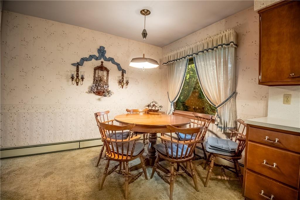 519 North Hermitage Road Hermitage, PA 16148 - Photo 16 of 38 a dining room with a wooden table and chairs