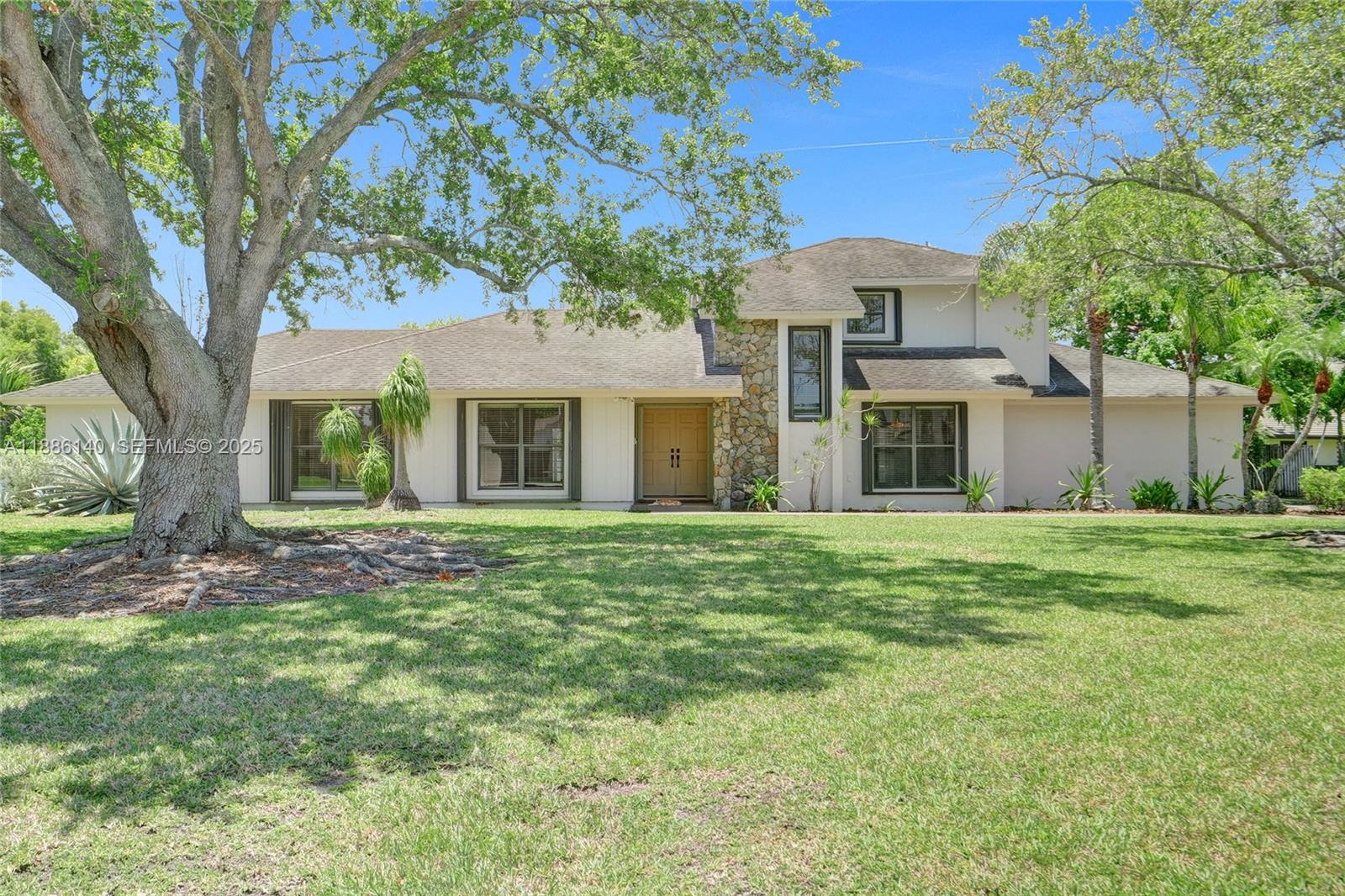 14940 Southwest 164th Terrace Miami, FL 33187 - Photo 13 of 73 a front view of a house with a garden