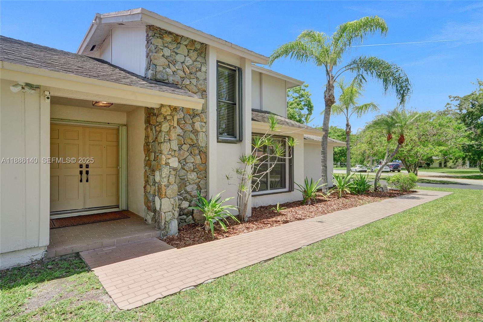 14940 Southwest 164th Terrace Miami, FL 33187 - Photo 17 of 73 a view of a house with a yard and potted plants