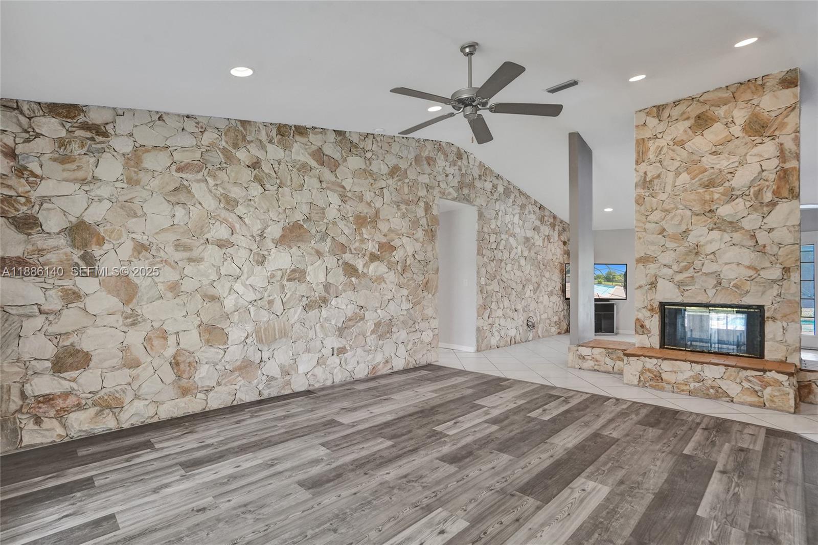 14940 Southwest 164th Terrace Miami, FL 33187 - Photo 18 of 73 a view of a livingroom with wooden floor and a fireplace